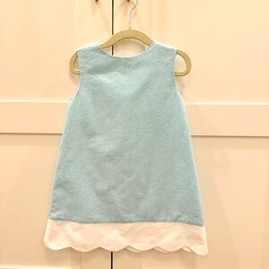 Elegant light blue dress accented with white trims, perfect for any occasion.